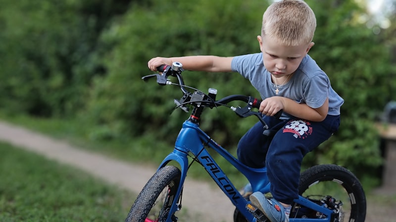 Child happily riding a bicycle outdoors