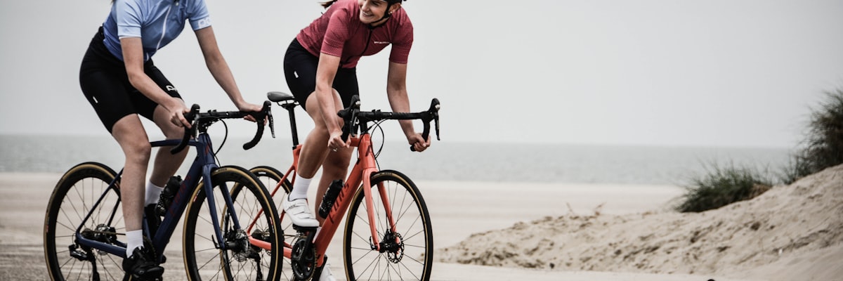 Cyclists riding on a sunny beach road